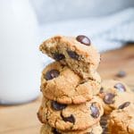 cookies stacked on plate with bottle of milk behind.