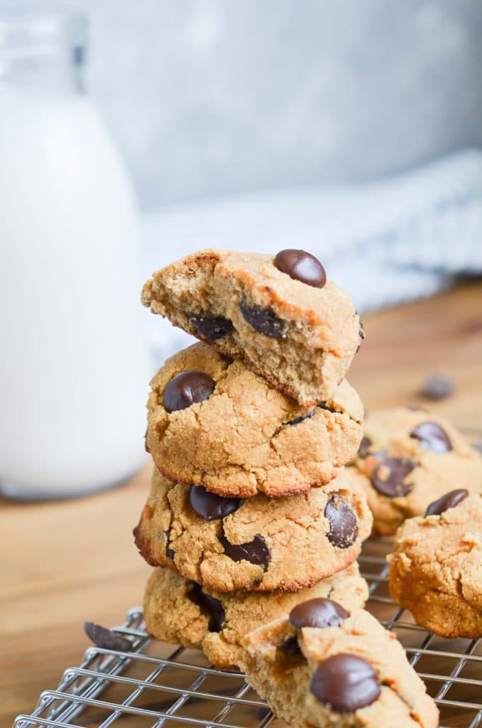 cookies stacked on plate with bottle of milk behind.