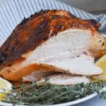 roast turkey breast being sliced on platter.