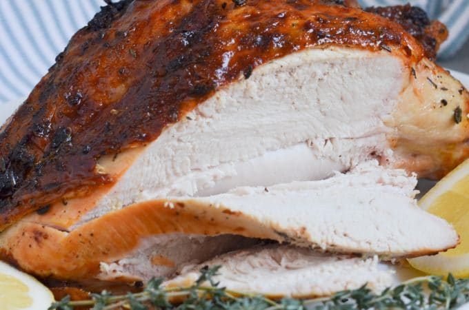 roast turkey breast being sliced on platter.