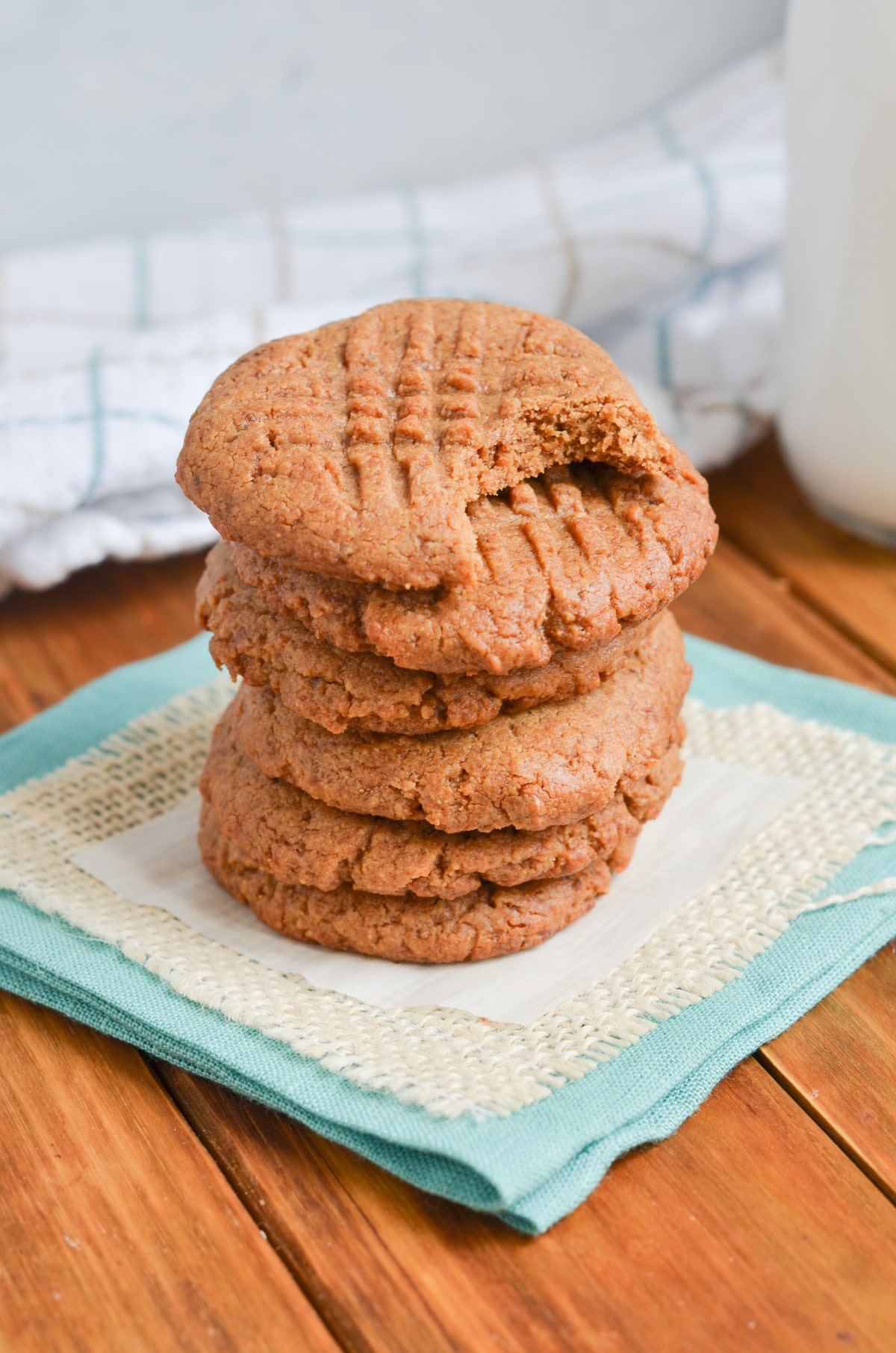 peanut butter cookies in a stack on a napkin.