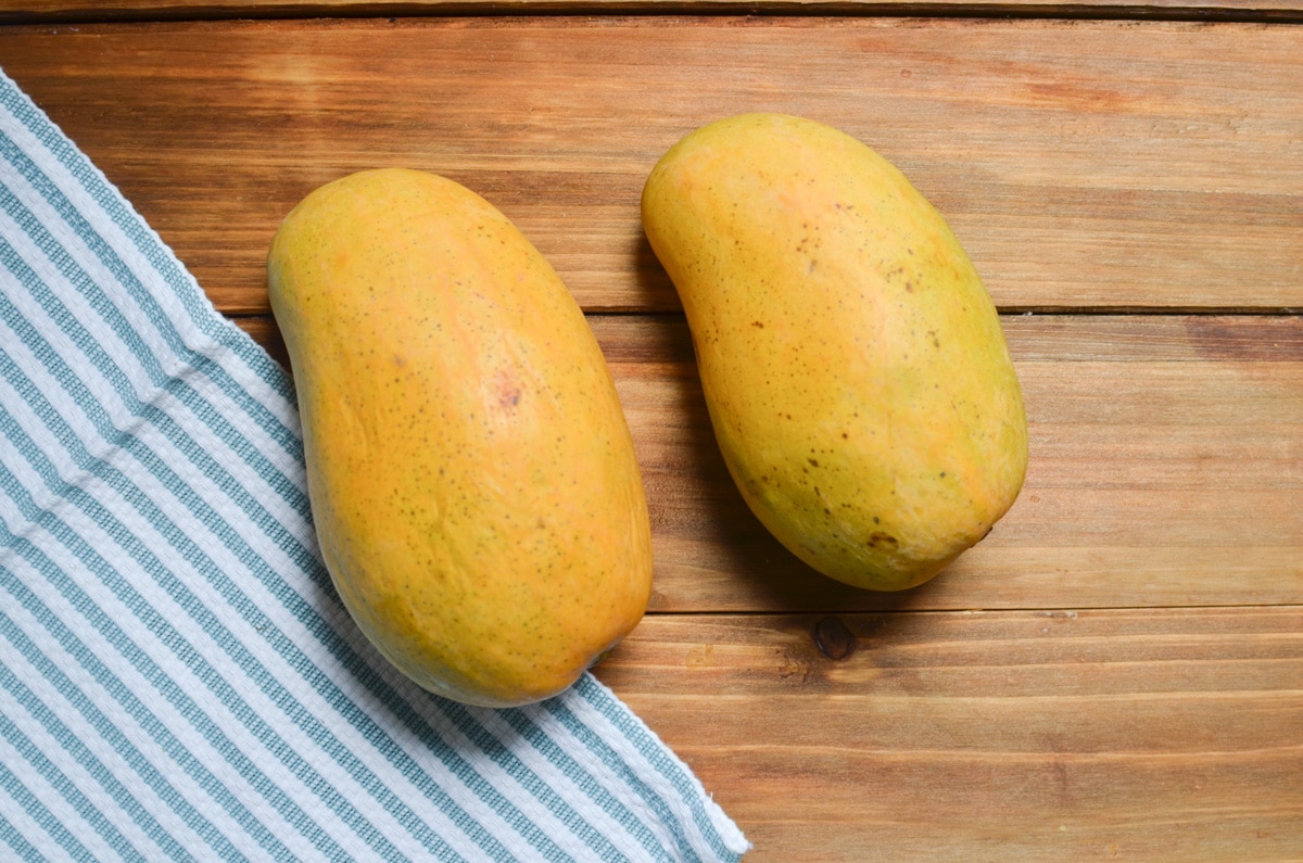 Two mangoes on the counter.