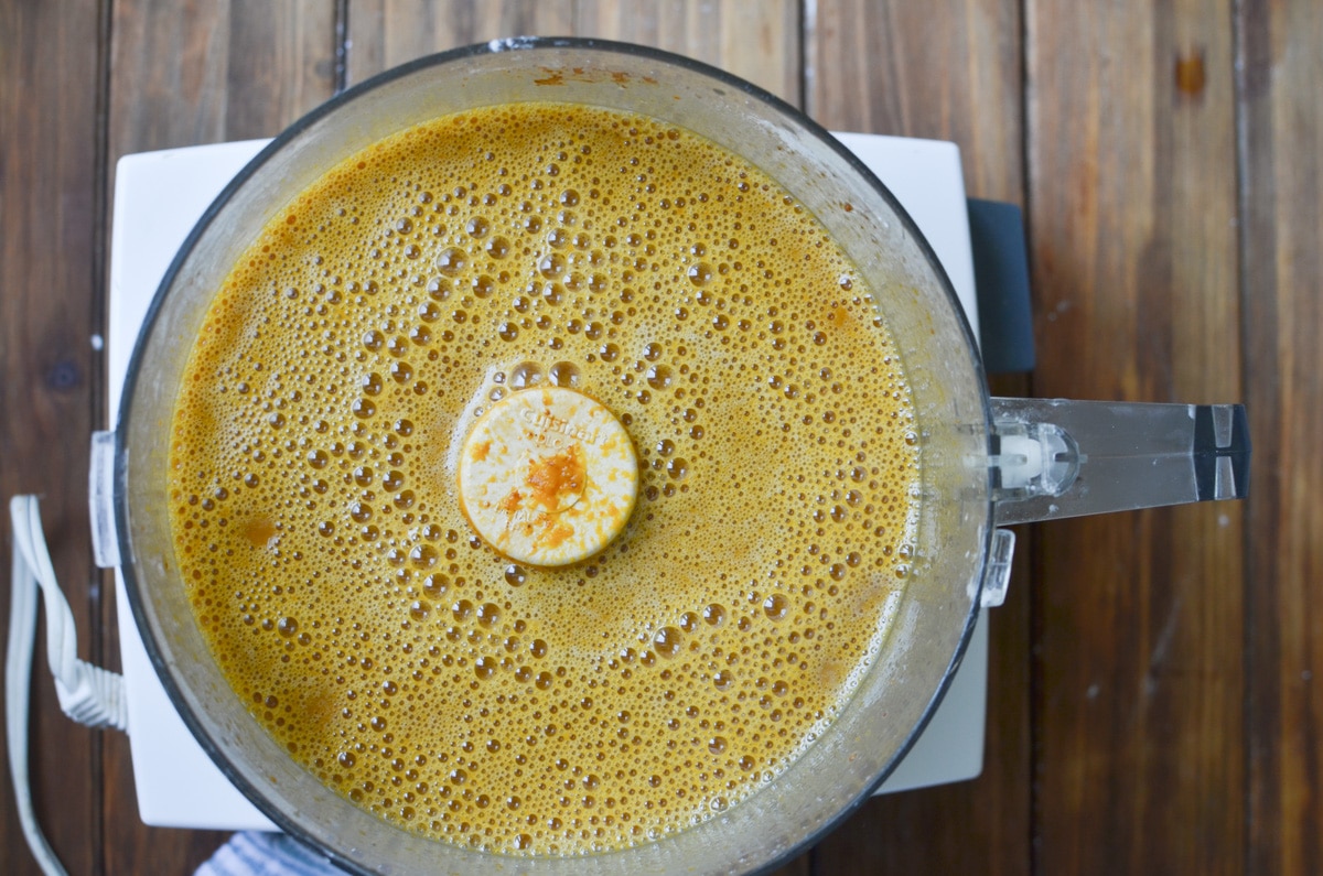 ingredients for pumpkin pie blended in food processor.