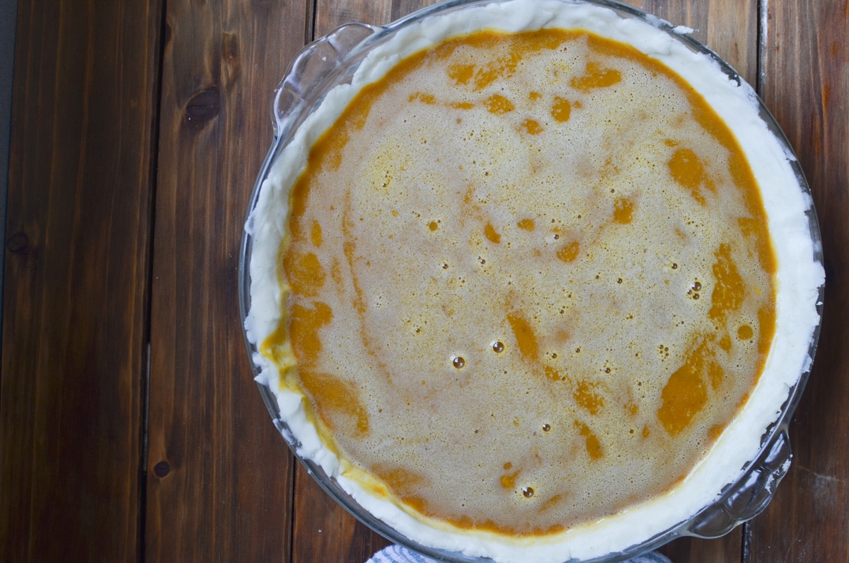 pumpkin pie filling in pie crust.