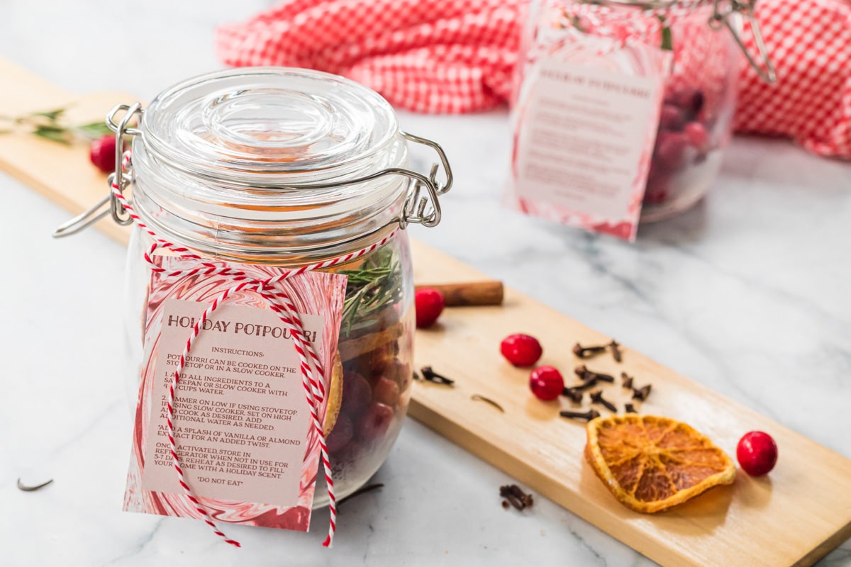 holiday potpourri in a jar with a ribbon and ingredient card.