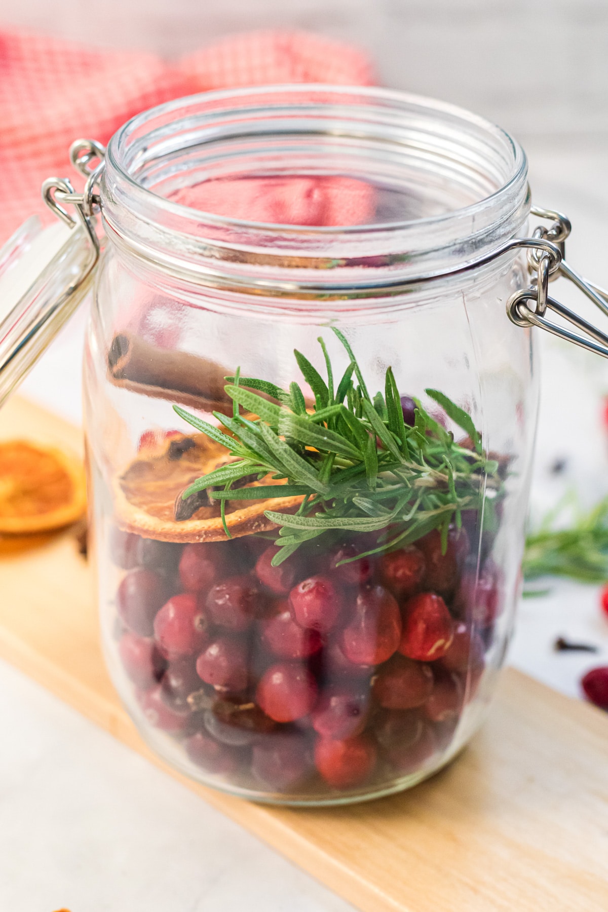 filling glass jar with potpourri ingredients.