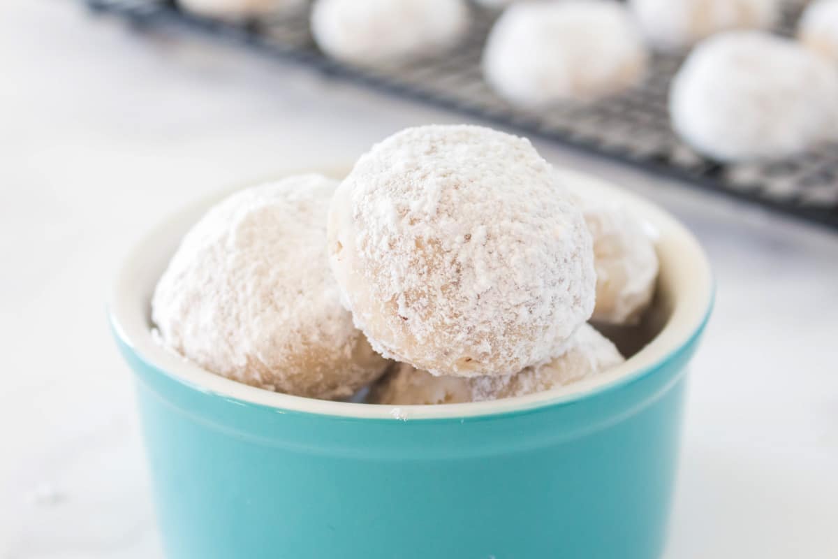 snowball cookies in a blue bowl.