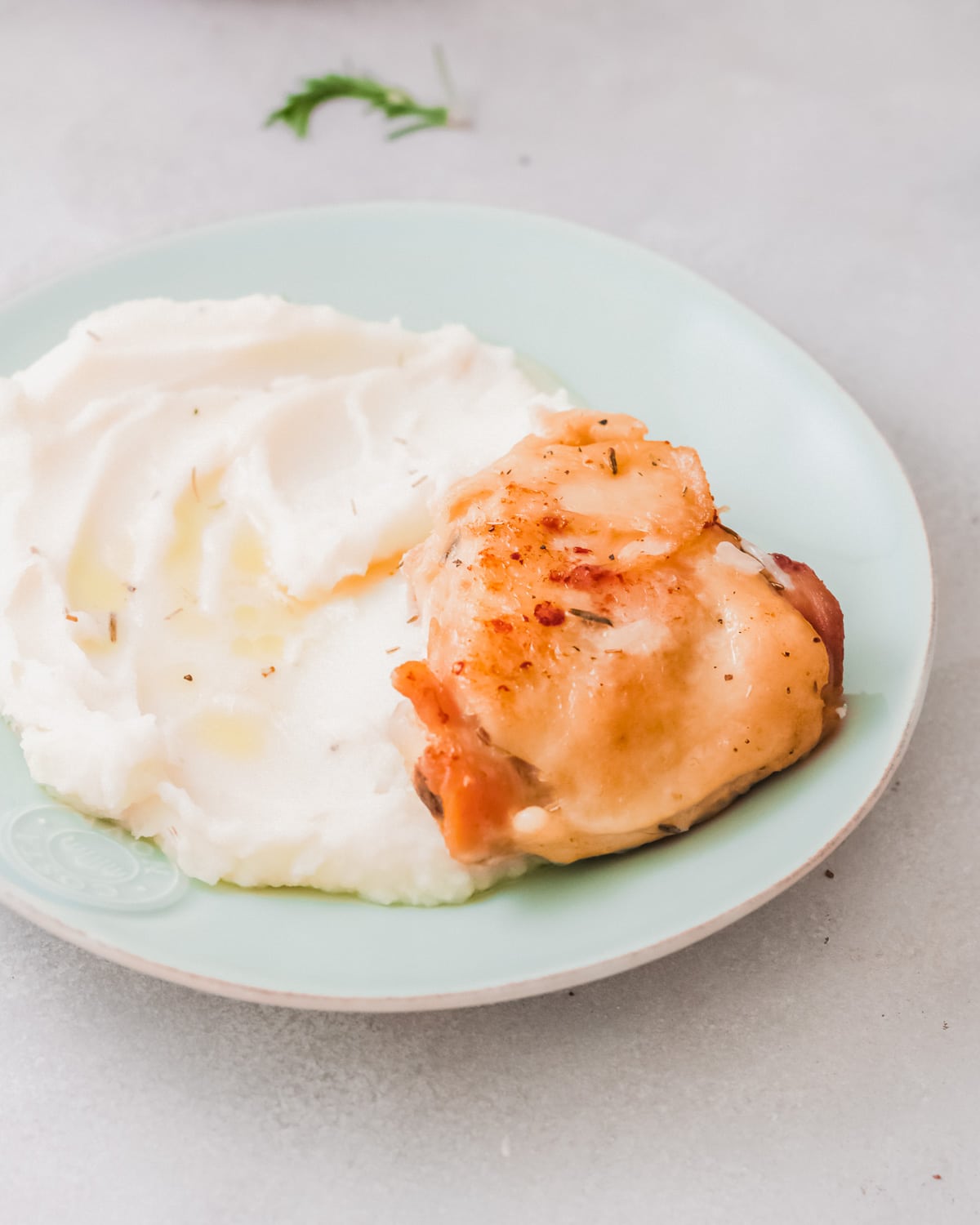 chicken and mashed potatoes on a plate.