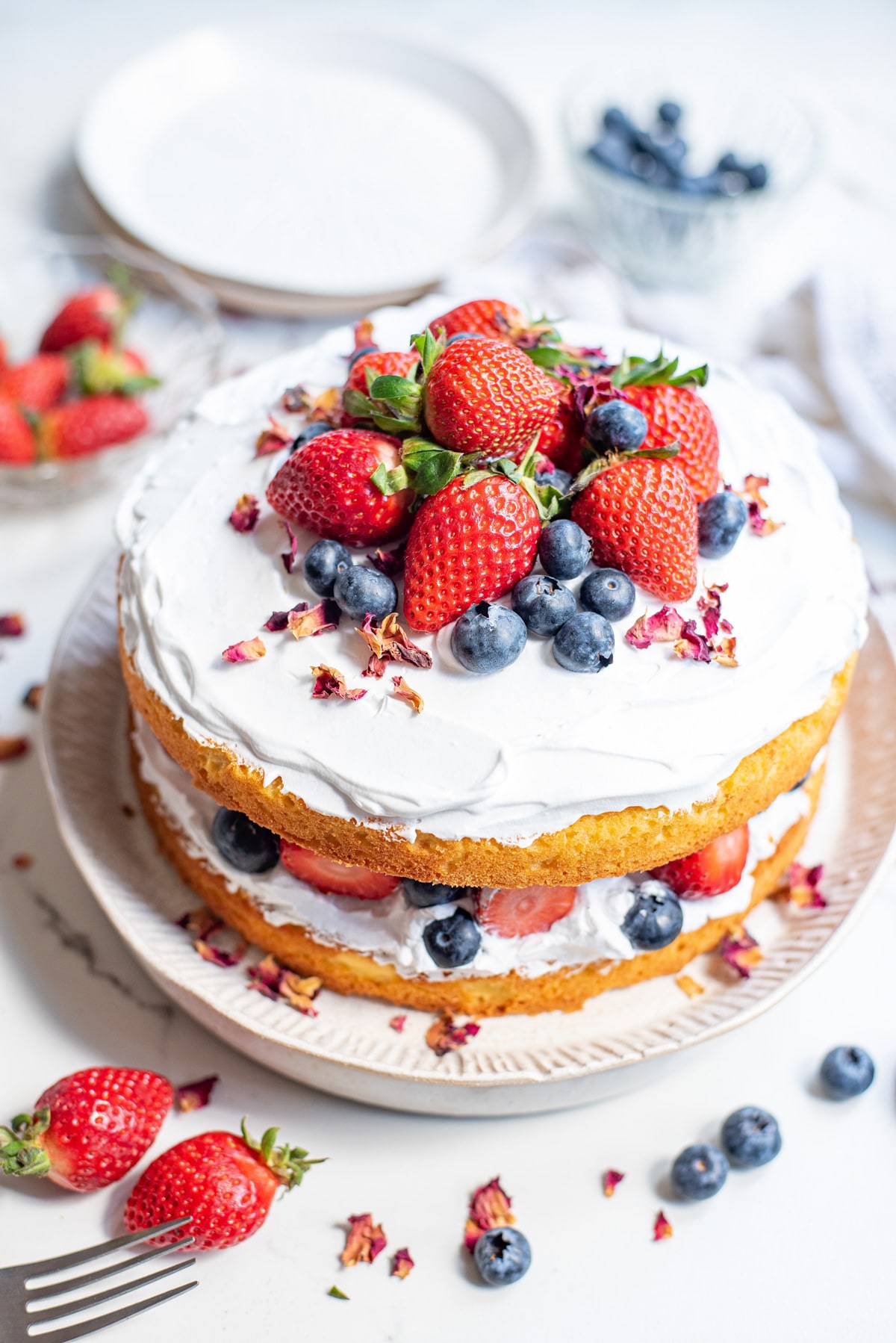 Decorated cake with whipped cream and berries.