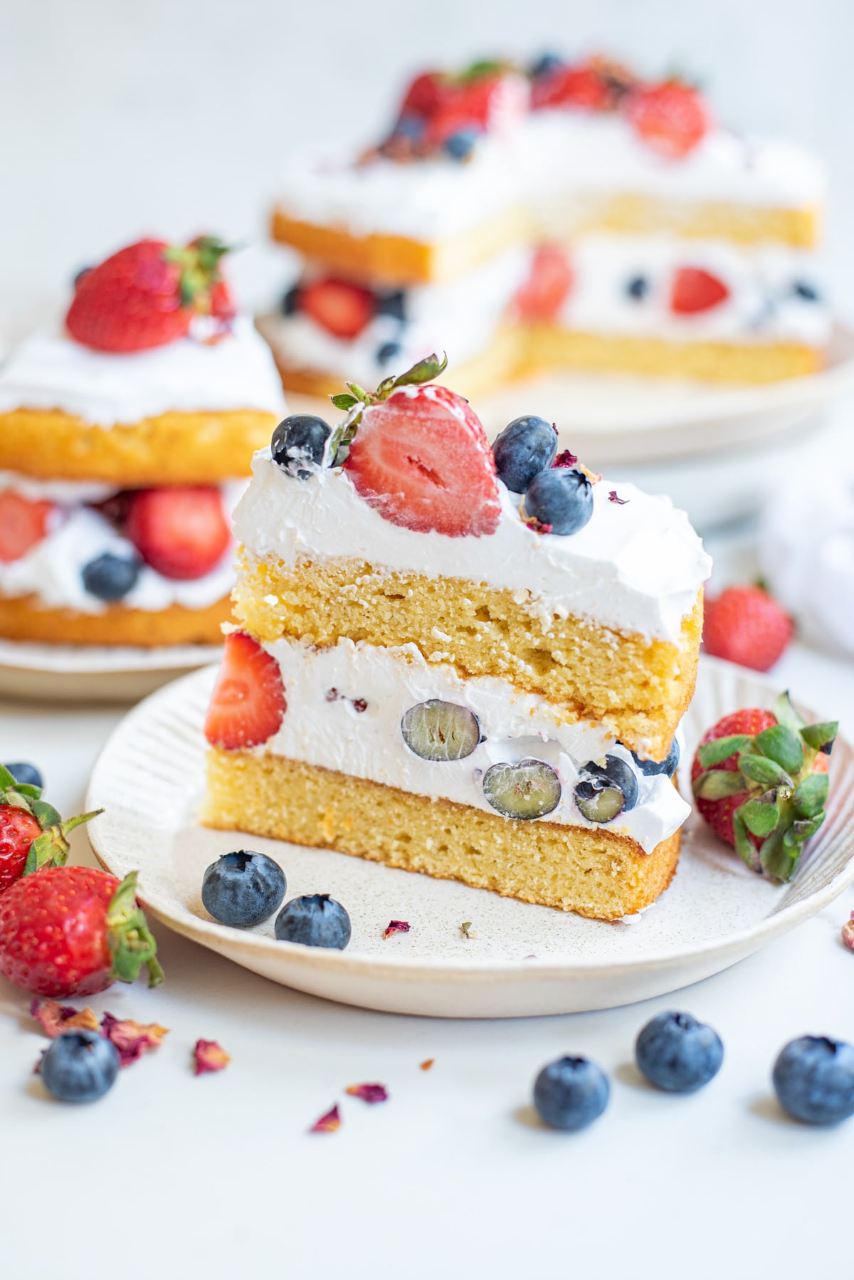 slice of coconut flour cake with whipped cream and berries.