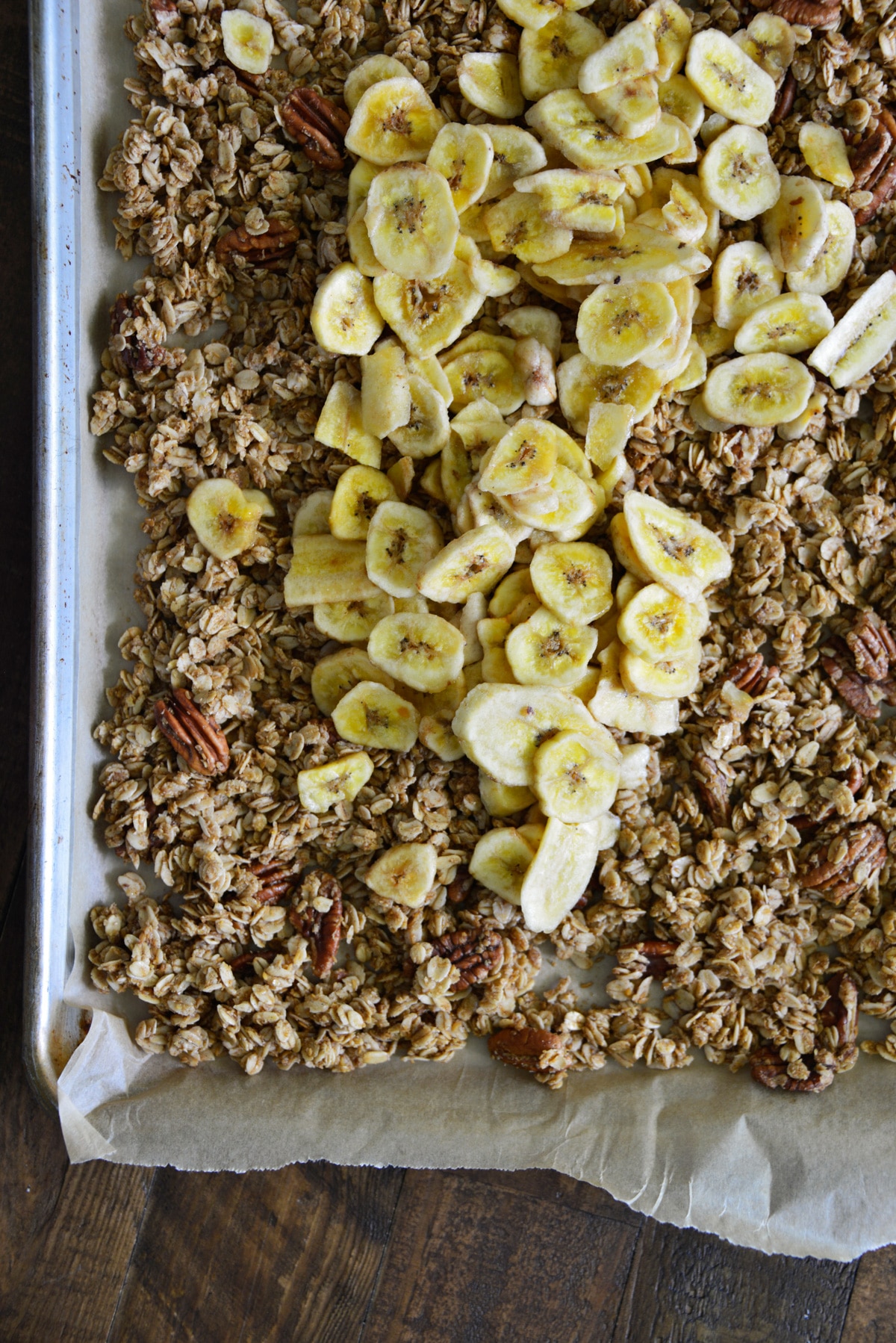 baked granola on pan with banana chips.